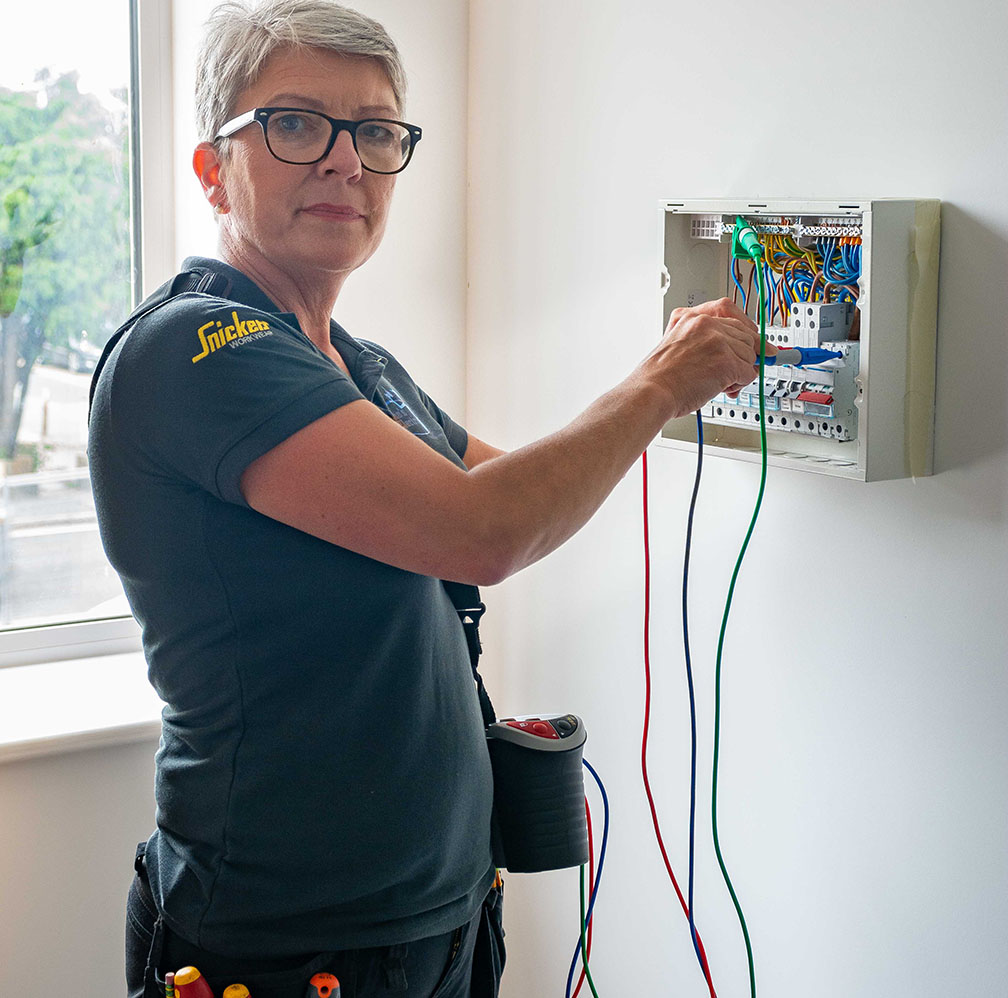 Consumer Unit and Fuse Board Upgrades - This image shows karen working on a fuse board