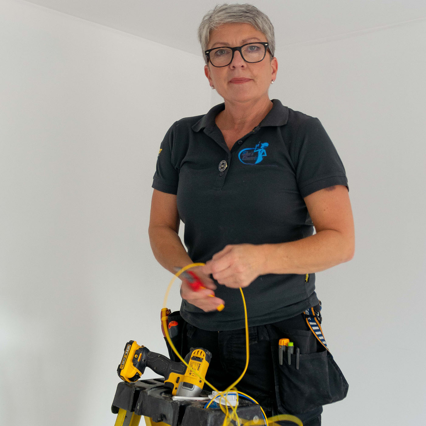 Extractor Fan Services this image shows Karen up a ladder about to start work on a new extractor fan