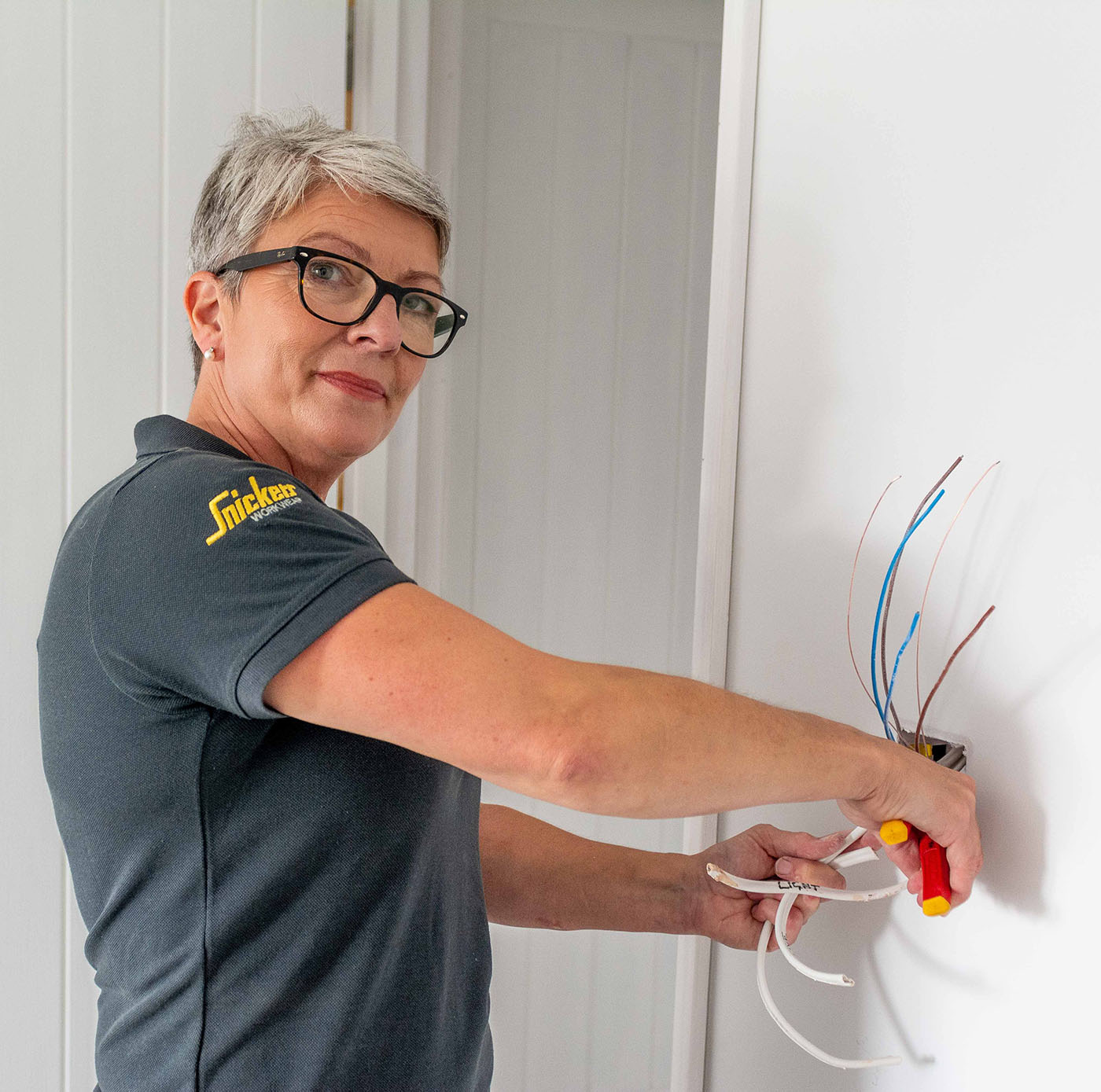 Lighting Services this image shows Karen installing a light socket in a new position